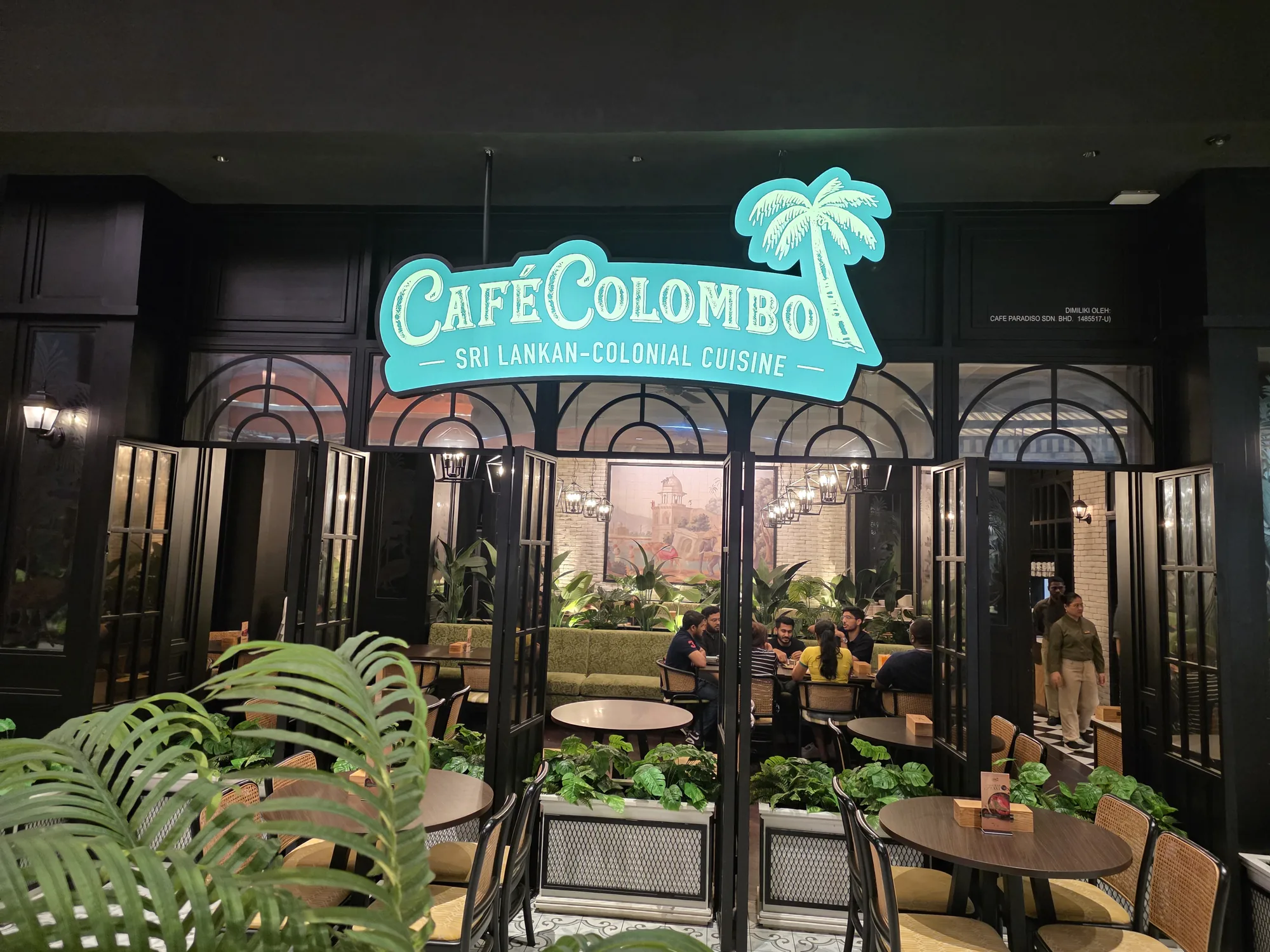 The illuminated entrance to Cafe Colombo at TRX