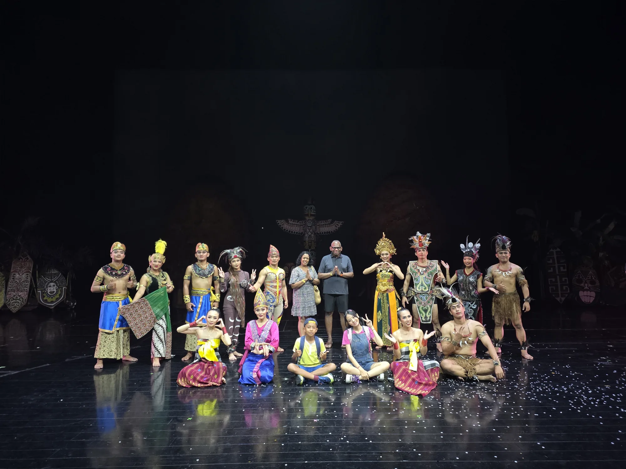 A group photograph with the Devdan performers on stage